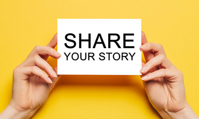 Female hands hold card paper with text Share your story on a yellow background. Business and...