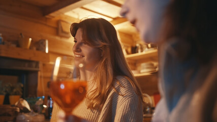 Young women, best friends having a drink in the bar during the winter vacation. Reunion concept. High quality photo