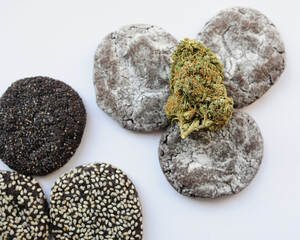 Marijuana blooms and sweets isolated on white background. Cannabis flowers and cookies close up. Hemp recreation, canna kitchen, pastime, legalization concept.