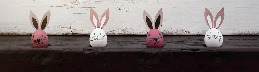 Happy Easter background banner panorama greeting card - Pink and white Easter eggs with bunny ears...