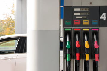Petrol pump filling nozzles at gas station