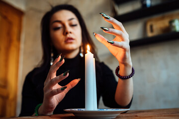 the girl is guessing on a lighted candle and cards, predicting the future and fate