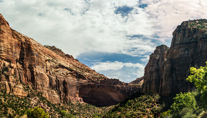 Emerging sandstone arch between high rock in american nature in Zion national park in Utah