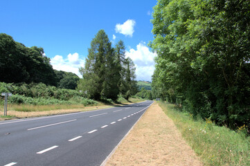 Fototapeta na wymiar Summertime road in the Welsh countryside.