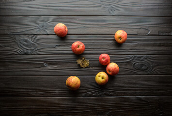 Top view of colorful apples lying on dark textured table