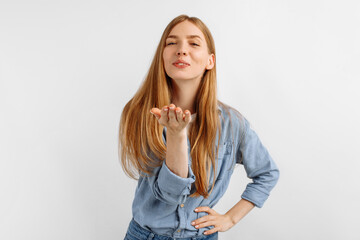 woman sends an air kiss, demonstrates her good feelings, on a white background