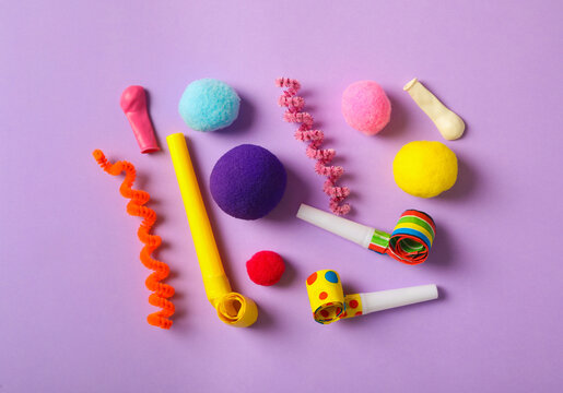 Different clown's accessories on lilac background, flat lay