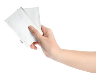 Woman holding medicine sachets on white background, closeup
