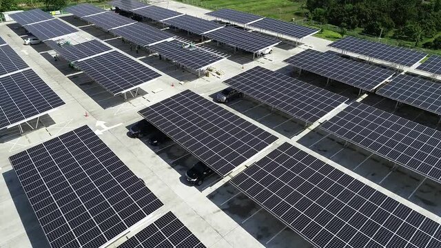 top view worker installing a solar cell on the factory roof.	