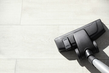 Modern vacuum cleaner indoors, closeup. Space for text