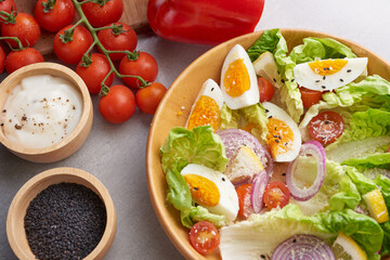 Diet menu. Healthy salad of fresh vegetables - tomatoes, egg, Onion. high angle view of a nutritious vegetable salad with boiled egg slices, served.  Healthy meal concept.
