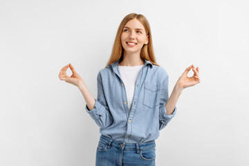 Young woman standing in meditative pose, enjoying peaceful , on white background