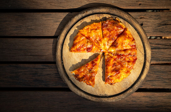 Home Made Margarita Pizza On An Old Round Wooden Cutting Board On Wooden Floor With Morning Outdoor Day Light, Easy Simple Homemade Food