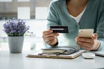 Online payment,hands holding a credit card and using smart phone for online shopping