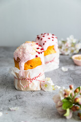 Traditional Easter cake, decorated with sugar decor icing, berries, flowers on grey background with copy space. Happy Easter Holidays