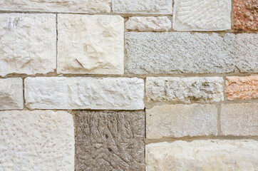 Wall made of stone and marble blocks of different texture