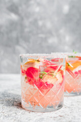 Grapefruit drinks with ice cubes and thyme