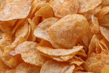 Potato chips or crisps . Close-up of potato chips or crisps. Food background.