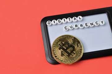 Golden bitcoin, name tag and alphabet beads with text DIGITAL CURRENCY over red background.