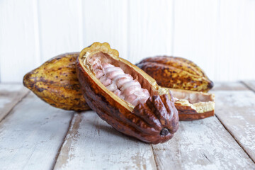 .Fresh cocoa pods and cocoa leaves on wooden background