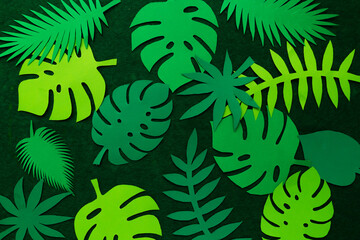 Naklejka na ściany i meble Abstract background from paper tropical leaves.