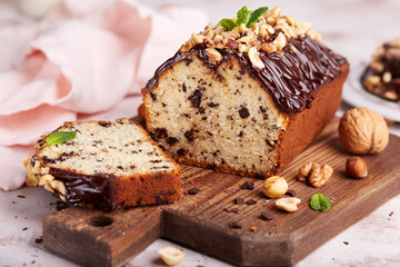 Fototapeta na wymiar Pound cake with chocolate walnuts and hazelnuts. Delicious homemade dessert. 