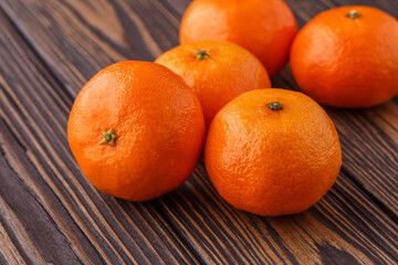 Mandarine orange or tangerine on wooden board