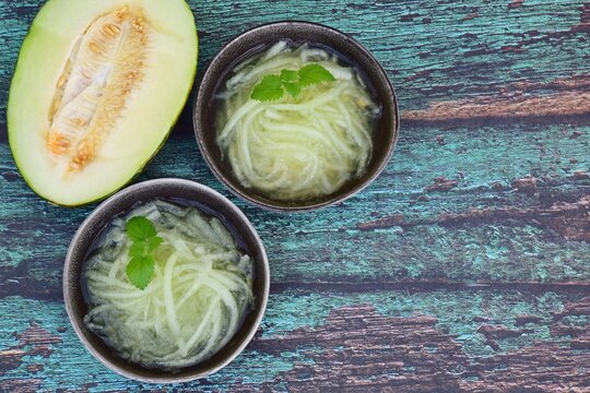 Es Blewah. Indonesian cold fruity drink of melon strips garnish with mint leaf