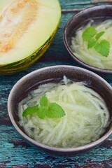 Es Blewah. Indonesian cold fruity drink of melon strips garnish with mint leaf