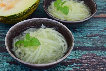 Es Blewah. Indonesian cold fruity drink of melon strips garnish with mint leaf