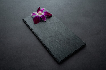 Black slate tray decorated with orchids