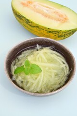 Es Blewah. Indonesian cold fruity drink of melon strips garnish with mint leaf