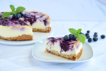 Blueberry cheesecake with mint leaf on white background