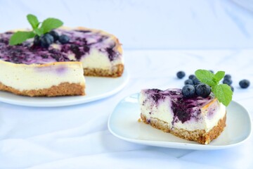 Blueberry cheesecake with mint leaf on white background