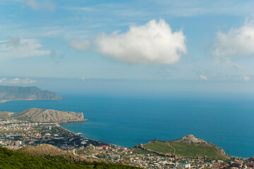 Panorama of the Crimean mountains with a view of the city of Sudak. Fortress view from the mountain on a sunny day.