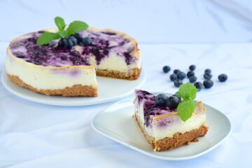 Blueberry cheesecake with mint leaf on white background