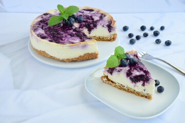 Blueberry cheesecake with mint leaf on white background