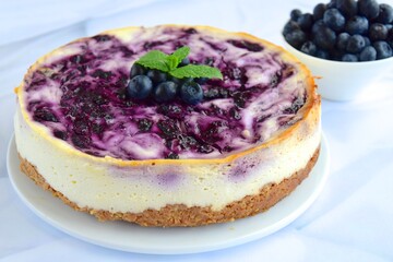 Blueberry cheesecake with mint leaf on white background