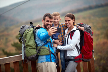 Cheerful hiker family making selfie