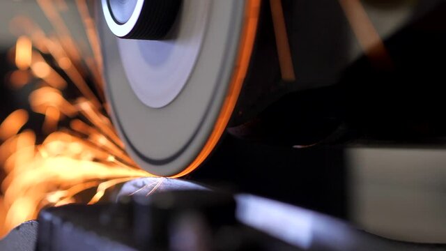 Close Up of Ice Skate Sharpened as the Stone hits the blade with Sparks Flying