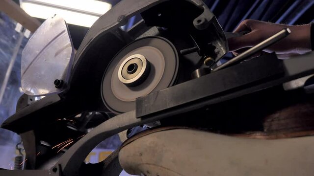 Wide View of Figure Skate Sharpened in Sharpener Machine in Local Hockey Shop