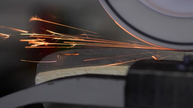 Close Up of Sparks hitting Hockey Skate Blade while getting Sharpened