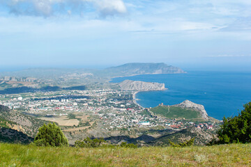 Panorama of the Crimean mountains with a view of the city of Sudak. Fortress view from the mountain on a sunny day.