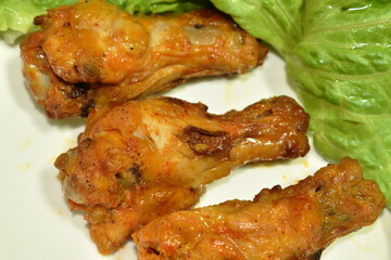 crispy fried chicken drum wing with barbecue sauce and vegetable on plate