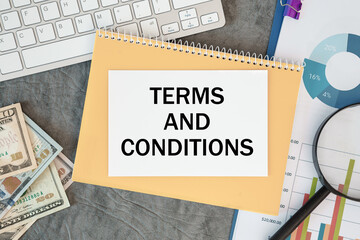 Terms and Conditions is written in a document on the office desk, money and diagram