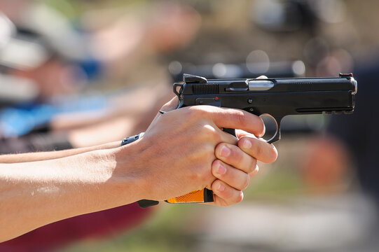 Close up of young hand on tactical gun training classes. Shooting and Weapons. Outdoor Shooting Range