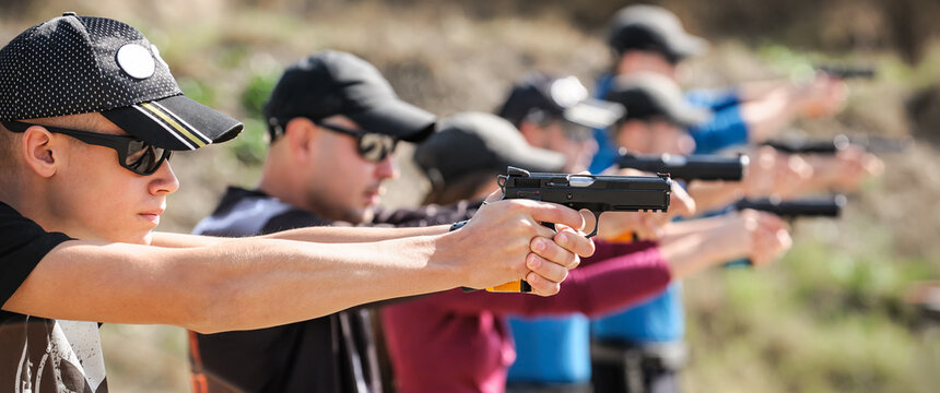 Young people on tactical gun training classes. Shooting and Weapons. Outdoor Shooting Range
