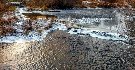Fast river with ice in late autumn