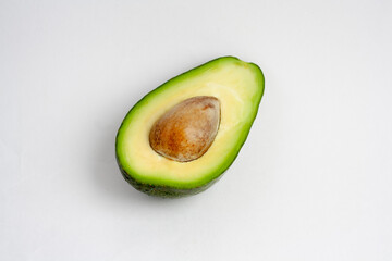 Half an avocado with a stone, isolated on a white background