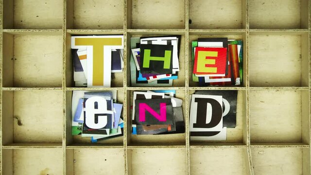 The End made up of magazine cut out letters in an old wooden box stop motion